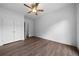 This bedroom includes wood-look floors, a ceiling fan and a large double-door closet at 3047 Standing Rock Ct, Lithia Springs, GA 30122