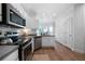 Well-lit kitchen features stainless steel appliances, white cabinets, and sleek countertops at 3047 Standing Rock Ct, Lithia Springs, GA 30122
