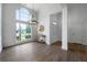 Open-concept living room with lots of natural light from large windows and wood-look floors at 3047 Standing Rock Ct, Lithia Springs, GA 30122