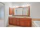 Bathroom features a double sink vanity with stone countertop and decorative mirror at 4305 Kendall Way, Roswell, GA 30075