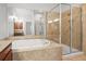 Luxurious bathroom with a large soaking tub, frameless shower, and tile surround at 4305 Kendall Way, Roswell, GA 30075