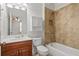 Bathroom with tiled shower over tub, built in shelf, and vanity with sink and storage at 4305 Kendall Way, Roswell, GA 30075