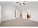 Spacious bedroom featuring neutral carpet, ceiling fan, and access to the ensuite bathroom at 4305 Kendall Way, Roswell, GA 30075