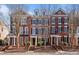 Charming brick townhomes featuring black shutters and well-maintained landscaping at 4305 Kendall Way, Roswell, GA 30075
