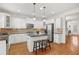 Bright kitchen with stainless steel appliances, island, and beautiful hardwood floors at 4305 Kendall Way, Roswell, GA 30075