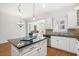 Modern kitchen with white cabinets, granite countertops, stainless steel appliances, and hardwood flooring at 4305 Kendall Way, Roswell, GA 30075