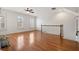 Upstairs living room with hardwood floors, natural light, and staircase at 4305 Kendall Way, Roswell, GA 30075