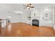 Spacious living room with fireplace, built-in shelving, hardwood floors, and abundant natural light at 4305 Kendall Way, Roswell, GA 30075