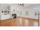 Bright living room with hardwood floors, built-in bookshelves, fireplace, and large windows at 4305 Kendall Way, Roswell, GA 30075