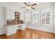 Sunlit office with custom built-in desk, storage, and large windows with wooden shutters at 4305 Kendall Way, Roswell, GA 30075