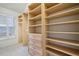 Expansive walk-in closet with built-in shelving and drawers at 4305 Kendall Way, Roswell, GA 30075