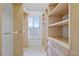 Well-organized walk-in closet featuring custom storage solutions and natural light at 4305 Kendall Way, Roswell, GA 30075