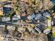 Aerial view of multiple apartment buildings, parking lots, and lush mature trees with blue sky at 449 Clairemont Ave # E1, Decatur, GA 30030