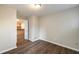 An empty bedroom with light walls, hardwood floors, and kitchen in view at 449 Clairemont Ave # E1, Decatur, GA 30030