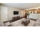 Inviting living room featuring hardwood floors, tv, and a view into the kitchen at 449 Clairemont Ave # E1, Decatur, GA 30030