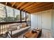 Relaxing covered patio with wood ceiling, comfortable seating, and views of the surrounding landscape at 449 Clairemont Ave # E1, Decatur, GA 30030