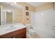 Well-lit bathroom with a single sink vanity, mirror and tiled shower-tub combo at 1094 N Village Dr, Decatur, GA 30032