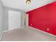 Comfortable carpeted bedroom with double door closet and red accent wall at 1094 N Village Dr, Decatur, GA 30032