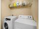 Modern laundry room featuring front loading washing machine and dryer with wire shelving at 1094 N Village Dr, Decatur, GA 30032