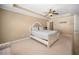 Bright main bedroom featuring a ceiling fan and a view to an ensuite bathroom at 1094 N Village Dr, Decatur, GA 30032