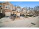 Charming townhomes featuring attached garages and manicured landscaping on a sunny day at 1094 N Village Dr, Decatur, GA 30032