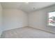 Bright bedroom with neutral carpet, a window, and white walls at 226 Linford Dr, Locust Grove, GA 30248