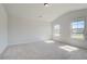 Large carpeted bedroom with two windows providing ample natural light at 226 Linford Dr, Locust Grove, GA 30248