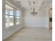 Elegant dining room with coffered ceiling, wainscoting, large windows and a stylish chandelier at 226 Linford Dr, Locust Grove, GA 30248