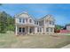 Inviting two-story home with brick and neutral siding, surrounded by greenery and a freshly cut lawn at 226 Linford Dr, Locust Grove, GA 30248