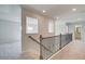 Upstairs hallway featuring carpet floors, and view into secondary rooms at 226 Linford Dr, Locust Grove, GA 30248