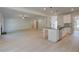 Open-concept living room and kitchen with wood-look floors, pendant lights, and an island sink at 226 Linford Dr, Locust Grove, GA 30248