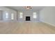 Spacious living room featuring a fireplace, wood-look floors, and natural light at 226 Linford Dr, Locust Grove, GA 30248