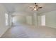 Large primary bedroom with tray ceilings, ceiling fan, and neutral walls and carpet at 226 Linford Dr, Locust Grove, GA 30248