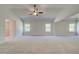 Spacious main bedroom with neutral carpet, a fan, and plenty of natural light at 226 Linford Dr, Locust Grove, GA 30248