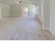 Bright main bedroom shows view to ensuite bath and neutral walls and carpet at 226 Linford Dr, Locust Grove, GA 30248