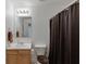 Bathroom featuring a wooden vanity, toilet, and shower with brown shower curtain at 2650 Richfield Pl, Cumming, GA 30040