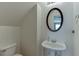 Bathroom featuring a pedestal sink, oval mirror, and neutral decor at 2650 Richfield Pl, Cumming, GA 30040