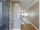 View of the entryway, showing the front door, hardwood floors, and a hallway leading to the stairs at 2650 Richfield Pl, Cumming, GA 30040