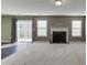 Bright living room with a fireplace, sliding glass door, and carpeted flooring, offering a cozy atmosphere at 2650 Richfield Pl, Cumming, GA 30040