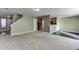 View of the living room with carpet and the kitchen area with bar top at 2650 Richfield Pl, Cumming, GA 30040