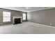 Spacious living room with a fireplace, ample natural light, and neutral paint, perfect for relaxation at 2650 Richfield Pl, Cumming, GA 30040