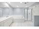 Bathroom featuring a soaking tub, glass shower, and tiled floor at 50 Biscayne Nw Dr # 2111, Atlanta, GA 30309