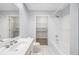 This bathroom has white tiled floors and walls, with a walk-in closet through the door at 50 Biscayne Nw Dr # 2111, Atlanta, GA 30309