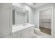 An ensuite bathroom features white cabinets, tile floor, and a walk-in closet at 50 Biscayne Nw Dr # 2111, Atlanta, GA 30309