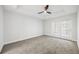 Carpeted bedroom with modern ceiling fan and French doors leading to outdoor space at 50 Biscayne Nw Dr # 2111, Atlanta, GA 30309