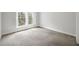 This bedroom features light gray walls and carpeting with a bright window at 50 Biscayne Nw Dr # 2111, Atlanta, GA 30309