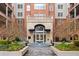 Elegant brick condominium building with a courtyard, fountain, and manicured landscaping at 50 Biscayne Nw Dr # 2111, Atlanta, GA 30309