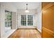 Sunlit eat-in kitchen featuring hardwood floors, white shutters, and natural light at 50 Biscayne Nw Dr # 2111, Atlanta, GA 30309