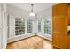 Sunlit eat-in kitchen featuring hardwood floors, white shutters, and natural light at 50 Biscayne Nw Dr # 2111, Atlanta, GA 30309