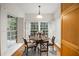 Sunlit eat-in kitchen featuring hardwood floors, white shutters, a dining table, and natural light at 50 Biscayne Nw Dr # 2111, Atlanta, GA 30309